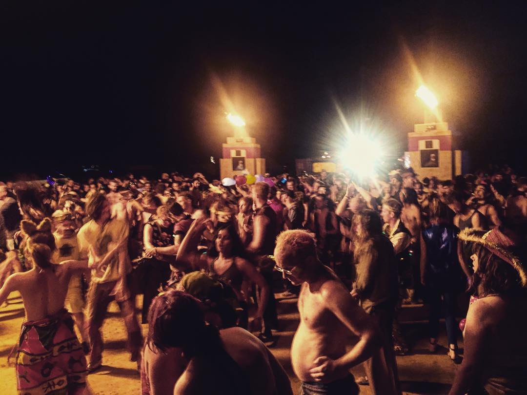 Burning Man crowd with fire towers